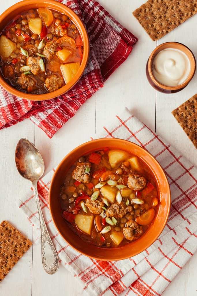 warm lentil and vegetable soup served hot in a bowl with winter vegetables